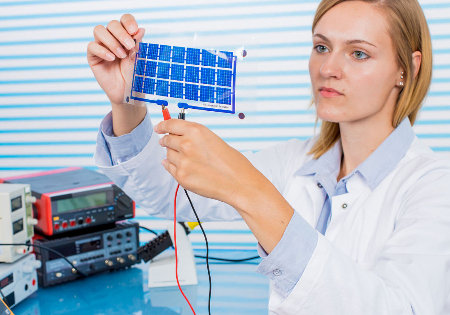 Image showing a technician testing a small film of solar cells
