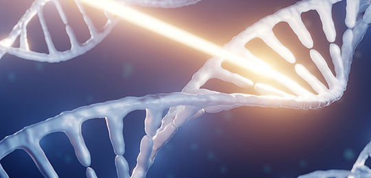 Artists impression showing a close up of three pale DNA strands against a dark blue background. The centre strand is being impacted and damaged by a bright beam of light