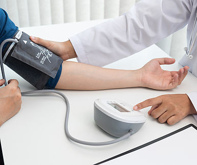 Image showing a doctor measuring blood pressure on the patient's arm with the blood pressure monitor in the hospital