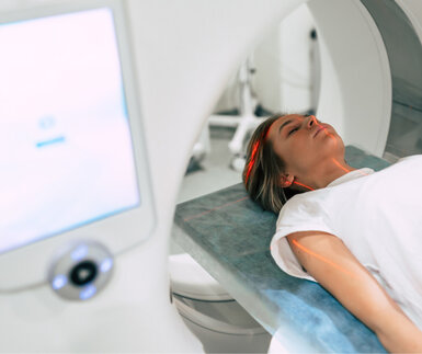 Image showing young woman patient ready to undergo magnetic resonance imaging in a modern hospital laboratory