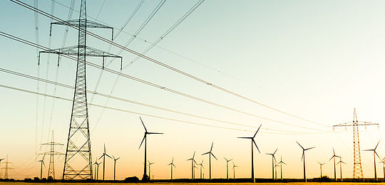 Power poles and wind turbines in autumn sunlight picture