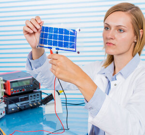 Image showing a technician testing a small film of solar cells
