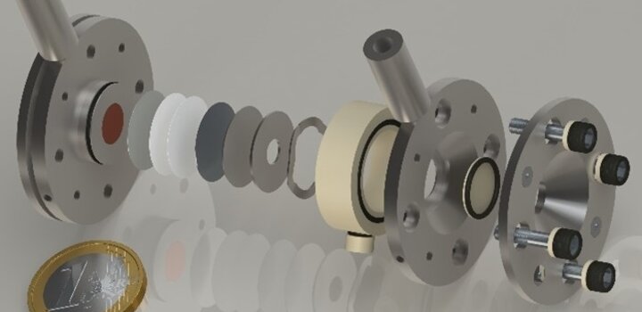 Computer-generated imagery of the vacuum-compatible operando battery cell in an explosion view was developed in OpMetBat. The specific design allows for the exchange of cell windows to address the different probes used in the project. The inner geometry represents the size of a CR2032 coin cell, which is mostly used in electrochemistry labs worldwide, and ensures a low barrier to interdisciplinary cooperation.