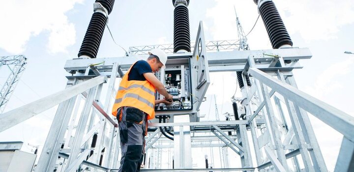 Engineer inspecting equipment in an electric substation