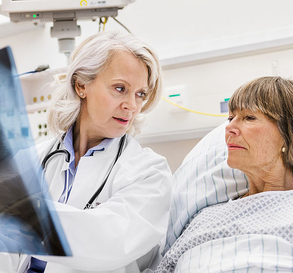 Image of a Doctor with patient examining an x-ray
