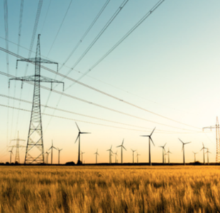 Image showing a large electricity pylon with wind turbines in autumn setting
