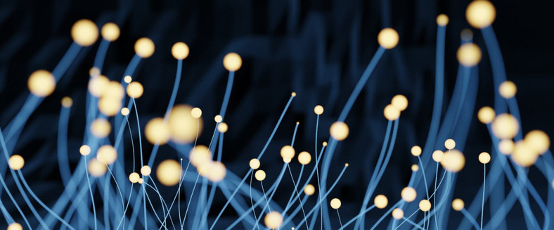 Against a black background in the foreground is a “forest” of pale blue nanowires with glowing tips 