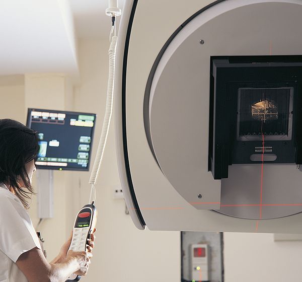 Image showing a Clinician operating a linear accelerator