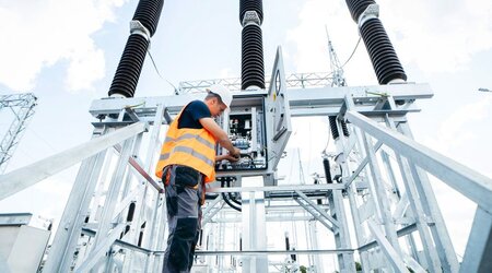 Engineer inspecting equipment in an electric substation