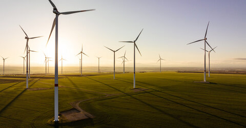 Image showing 17 turbines in a rural wind farm against the sunrise