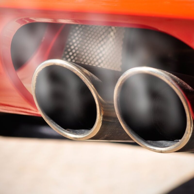 Providing the metrology to support emission legislation Image showing a Car dual exhaust pipe with smoke