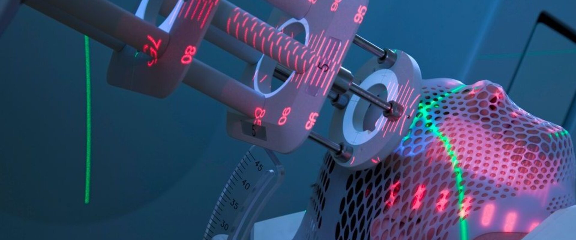 Patient receiving treatment for cancer Close up of a man’s head wrapped in protective gauze with the head of a radiation delivery instrument pressed to his temple