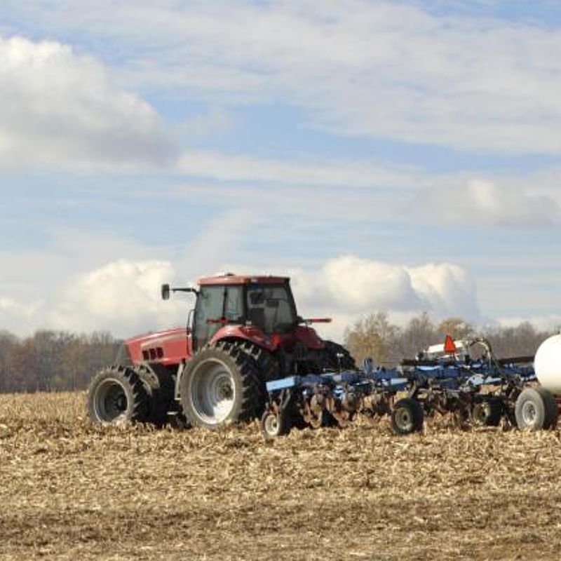 Developing the technology to accurately measure ammonia Image showing a tractor plowing and fertilising a field