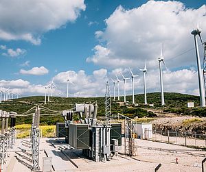 Renewable green energy - power substation and wind turbines Image showing renewable green energy - power substation and wind turbines