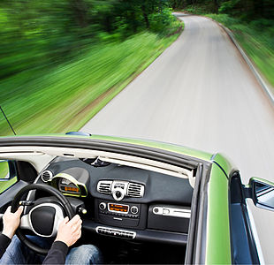 Image showing an electric car driving down an empty road