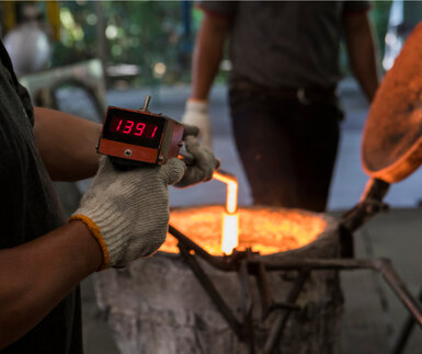 Image of worker measuring temperature at industrial site