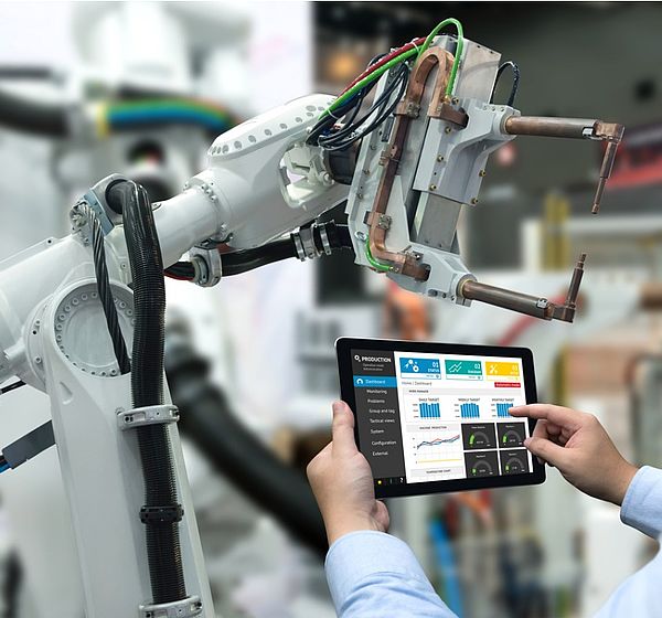 Image showing an Engineer controlling a robot arm in smart factory