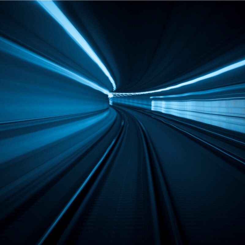 Image showing blue-white light trails in a tunnel