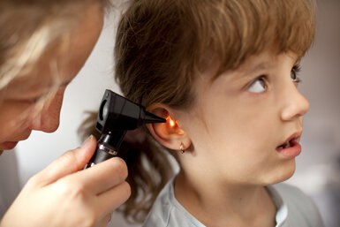 Image showing a Paediatrician performing an ear exam of a young patient