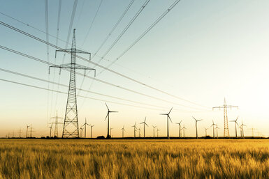 Image showing power lines and wind turbines in autumn sunlight