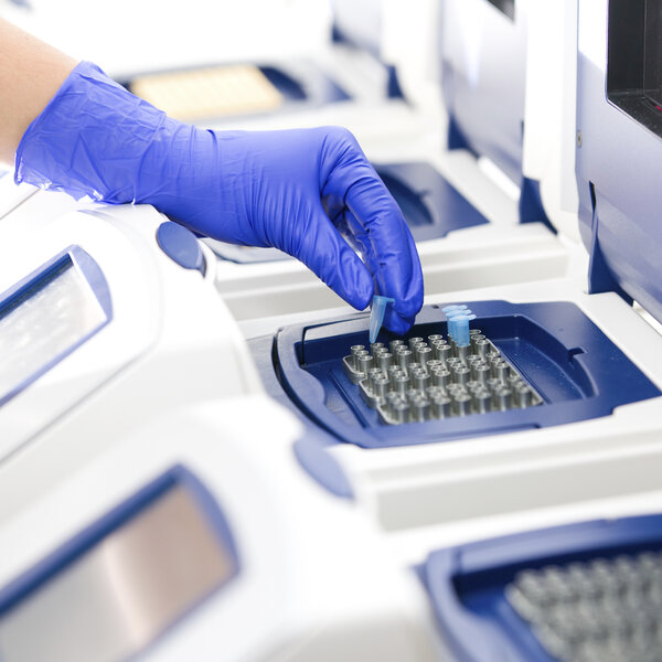 Image of a scientist using a real-time cycler to copy DNA