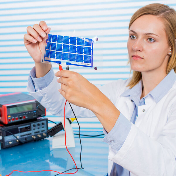 Image showing a technician testing a small film of solar cells
