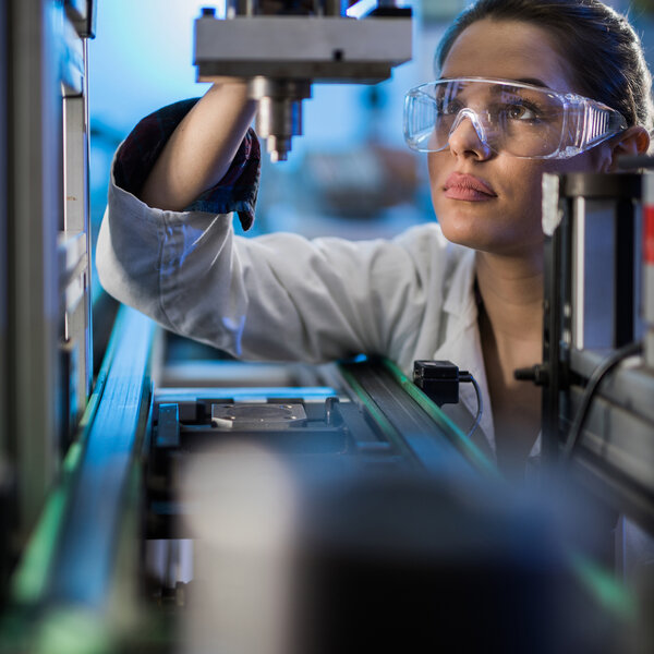 Image showing an Engineer examining machine part on a production line during performance testing
