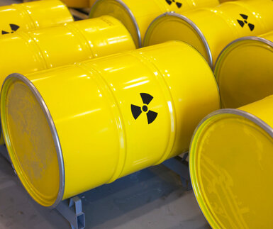 Image showing rows of yellow radioactive waste barrels