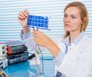 Image showing a technician testing a small film of solar cells