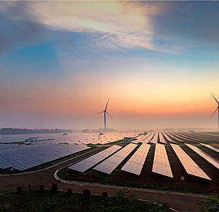 Image showing solar panels and wind turbines at sunrise