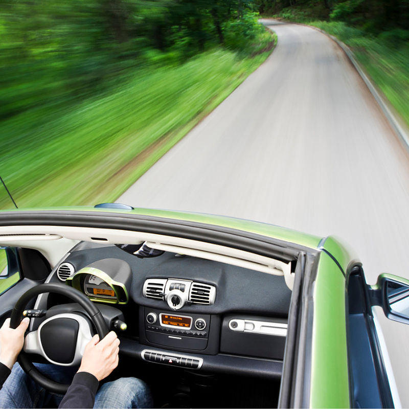 Addressing the metrological challenges for electric vehicles Image showing an electric car driving down an empty road