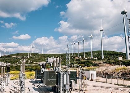 Renewable green energy - power substation and wind turbines Image showing renewable green energy - power substation and wind turbines