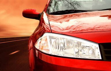 Image showing the right side of a red sportscar on a highway