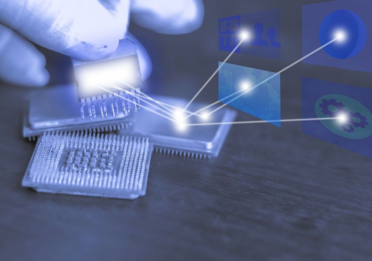 Image showing a gloved hand holding a silicon chip with rays of light reflecting from it