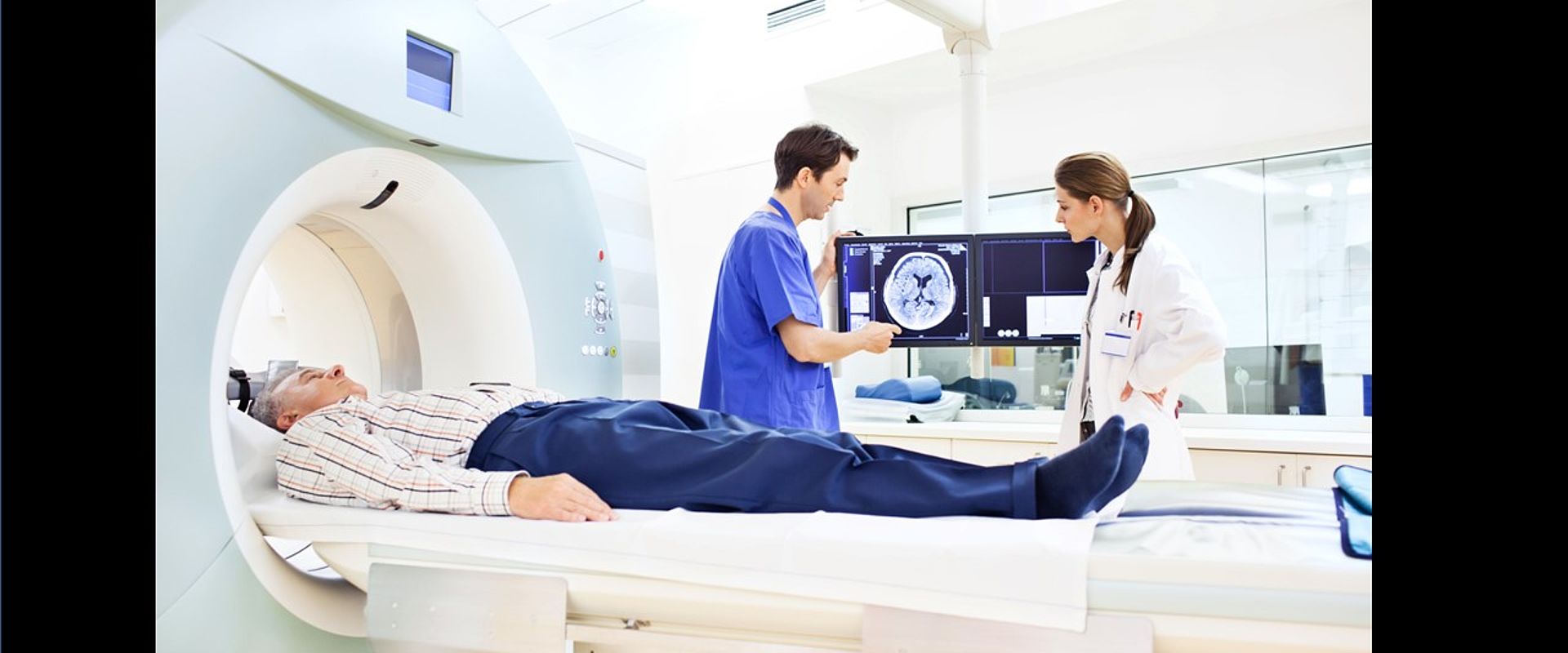 Two doctors discussing a CAT scan Image showing Two doctors discussing a CAT scan