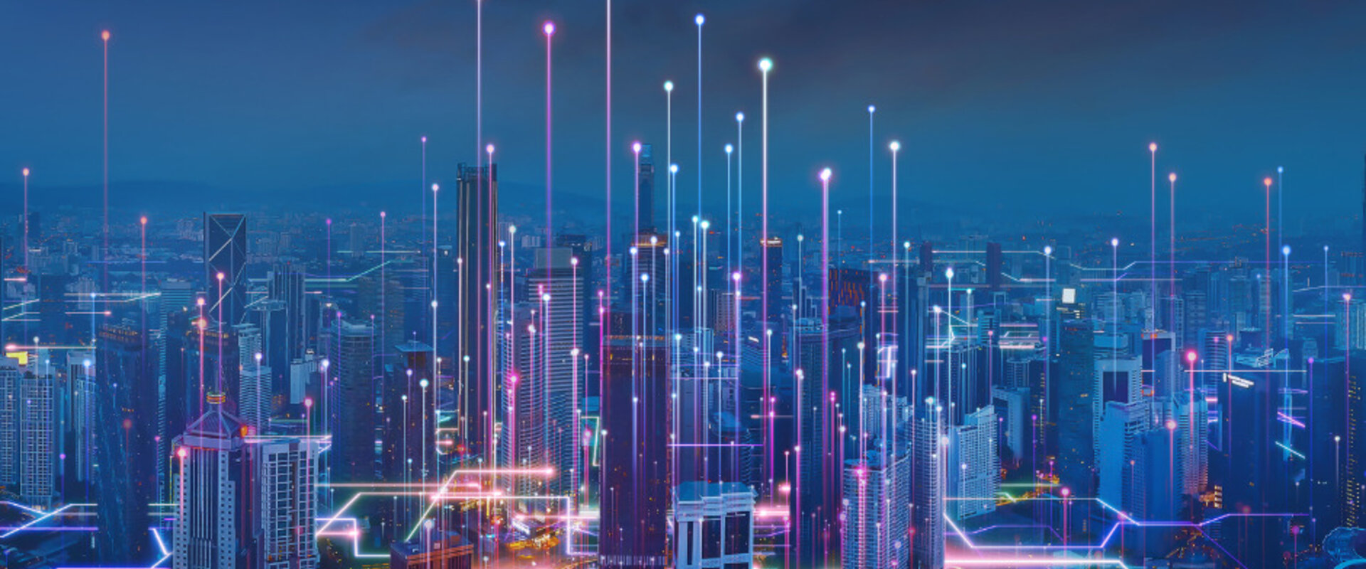 Artists impression of a “smart city” at night with vertical shafts of light rising from the buildings which are linked with glowing lines