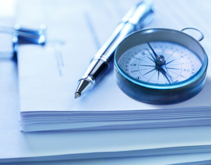 Image showing compass and pen on a stack of legal documents