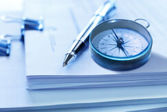Image showing compass and pen on a stack of legal documents