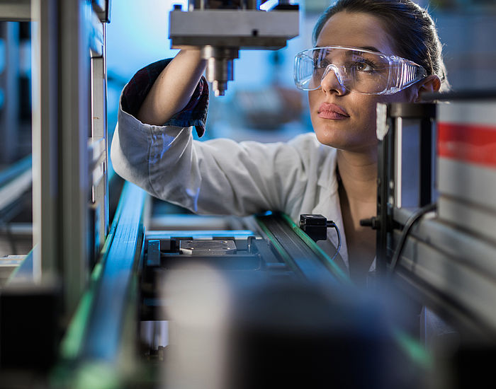 Image showing an Engineer examining machine part on a production line during performance testing