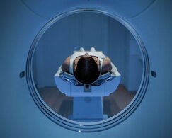 Image showing female patient lying on MRI scan bed 
