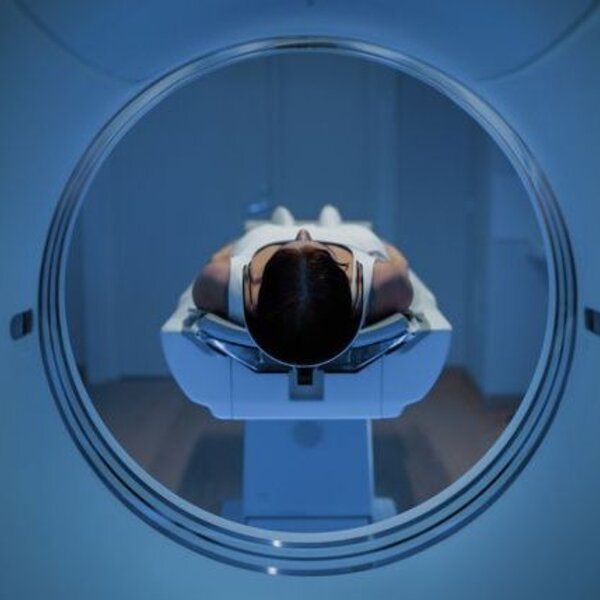 Image showing female patient lying on MRI scan bed 