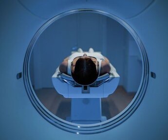 Image showing female patient lying on MRI scan bed 