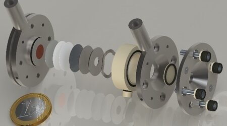 Computer-generated imagery of the vacuum-compatible operando battery cell in an explosion view was developed in OpMetBat. The specific design allows for the exchange of cell windows to address the different probes used in the project. The inner geometry represents the size of a CR2032 coin cell, which is mostly used in electrochemistry labs worldwide, and ensures a low barrier to interdisciplinary cooperation.