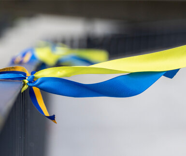 Ribbons in the colors of the national flag of Ukraine tied to a handrail
