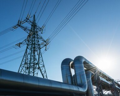 Image showing Industrial pipelines on pipe-bridge against blue sky