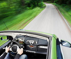 An electric car driving down a road Image showing an electric car driving down an empty road