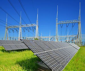 Solar energy panels in the background high voltage power substation