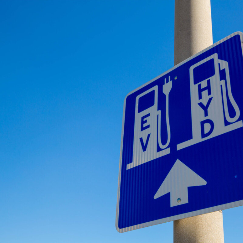 Developing metrology for zero-carbon hydrogen vehicles Image showing a sign for an Electric vehicle and hydrogen refueling station