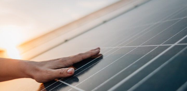 Image showing a hand touching a solar panel